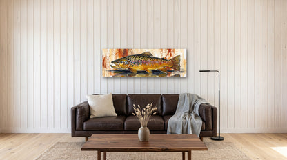 Legends Bold Autumn Brown Trout 48x16 canvas over a leather sofa in a modern lake cabin